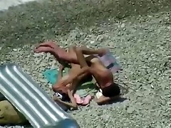 Two teenagers are coupling on the seashore lazily as they didn't sleep the whole night! Maybe they hurry up a little if they know about the spy cam near them!
