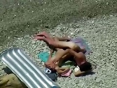 Two teenagers are coupling on the seashore lazily as they didn't sleep the whole night! Maybe they hurry up a little if they know about the spy cam near them!